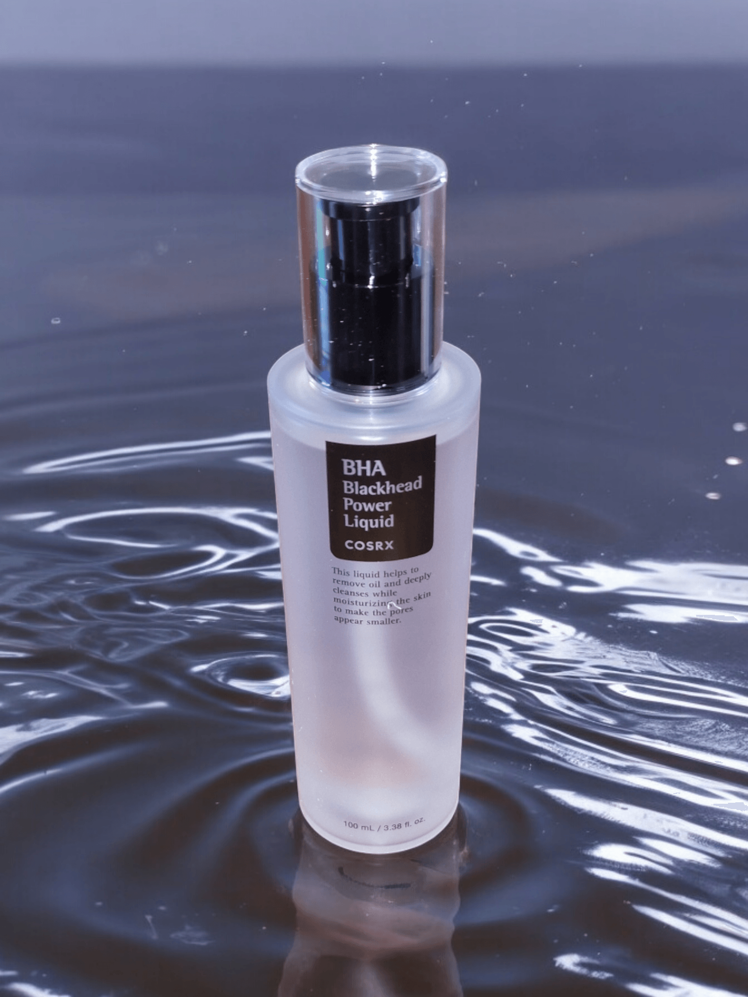 COSRX - BHA Blackhead Power Liquid with a black water background with ripples 